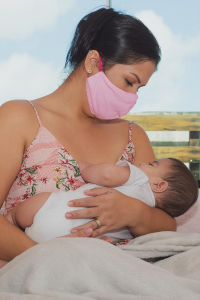 Mom nursing baby with mask
